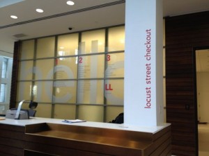 ABOVE: The glass wall behind the Locust St circulation desk was made from the old glass floors in the 7-story stacks area