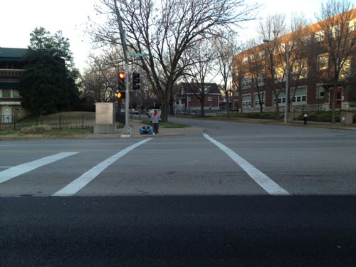 ABvOVE: A woman waited on the other side of Kingshighway also waiting for the walk signal to come on. 