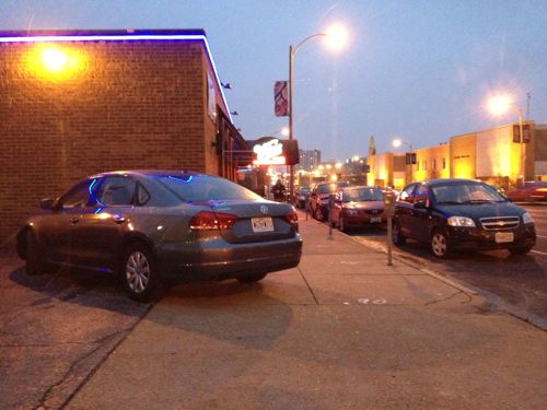 ABOVE: Tail end of a car at Vito's takes up half the public sidewalk