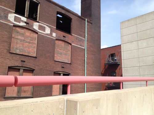 Residents sit on their balcony in the loft building to the east (right)