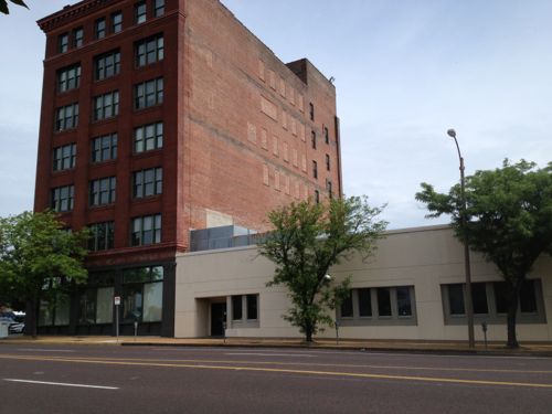 The rest of this block-face to 21st is these two buildings with the same ownership. The one on the left was built in 1903, the former Hamilton-Brown Shoe Factory. The one-story building on the right is from 1955. A taller building could replace the one on the right.  