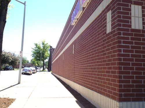 The north side facing Victor St has a red brick veneer, but no doors or windows. 