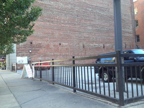 Small private parking lot, 10th & Olive, provides parking for commercial spaces in two nearby buildings. 2013 photo. 