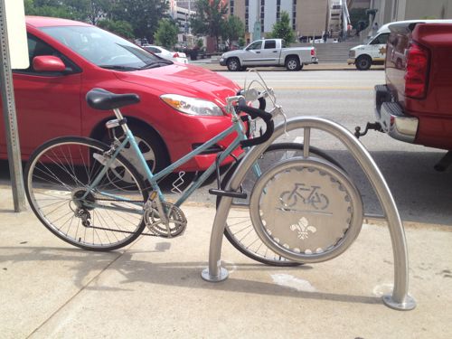 This bike is not properly placed, it is taking up extra space on the sidewalk and could tip over. 