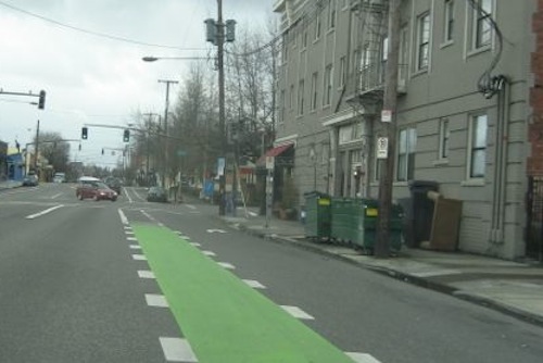 The places where cars are allowed to cross bike lanes for right turns are very clear in Portland OR. 