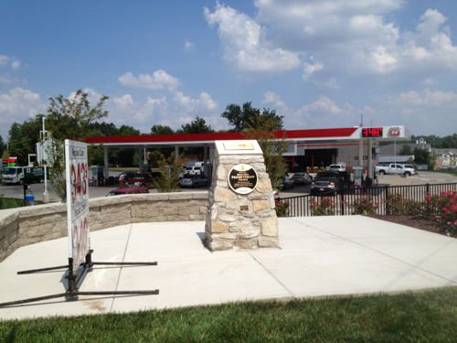 Now on the corner a sign notes current gas prices and a monument notes the history that was lost 