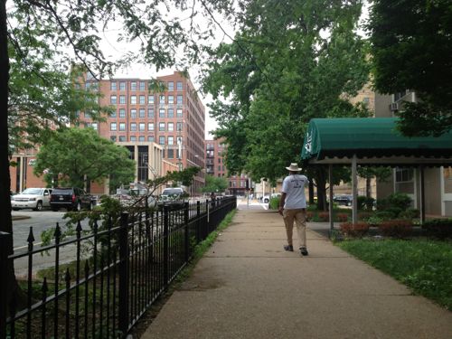 Looking north on the walkway  before renovation of the adjacent building began. This area became a haven for trouble once that building became vacant, the church had the fence installed then.