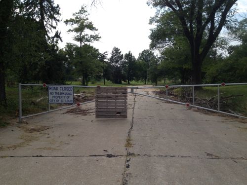 A gate blocks access to Celburne Ln from Woodford Way Dr on the west side of I-270. Click image for map.