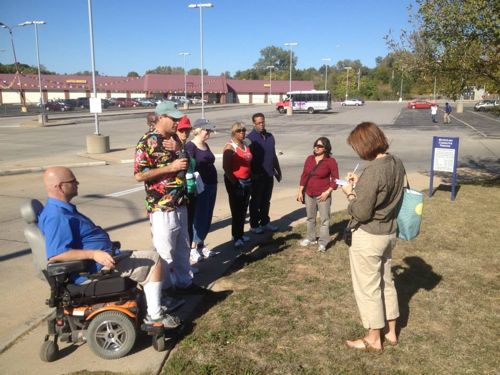 We started at the ticket machines, our first stop was the entry. Half did a straight shot through the parking lot, the rest of us went the long way on the sidewalk. Photo: CMT