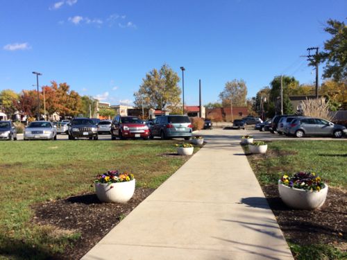 The view from the entry shows the original walk leading to parking  