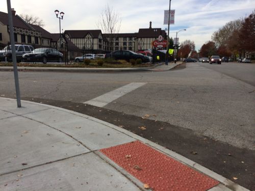 Looking west from the opposite side. Again, the ramps and detectable warnings used to guide the visually-impaired aren't directional.   