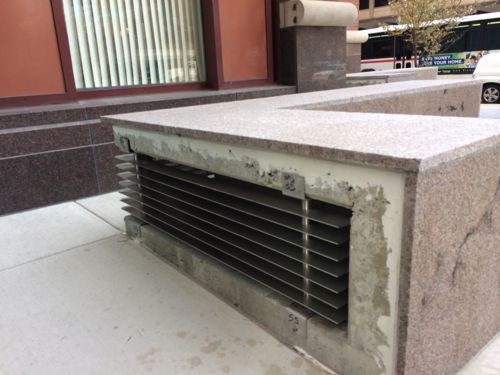 The back of the stone benches is where exhaust from the underground parking parking garage is vented.  