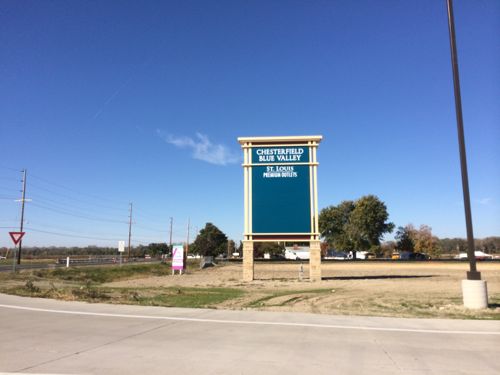 This mall is in the center of a much larger site that'll eventually all be developed.  The entrance signs have room for other projects besides the outlet mall