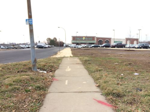 The sidewalk remains from when 14th was a public street. Pedestrians entering via 14th will have to walk in the grass since the sidewalk wasn't continued.