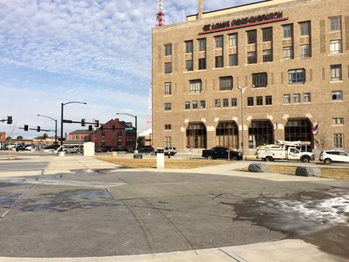 The continuous MLK Dr begins at Hadley St, one block east of Tucker. Post-Dispatch on the north side, the rebuilt plaza formerly named Interco Plaza. 