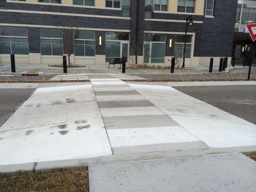 A raised crosswalk brings the crosswalk up to the level of the sidewalk