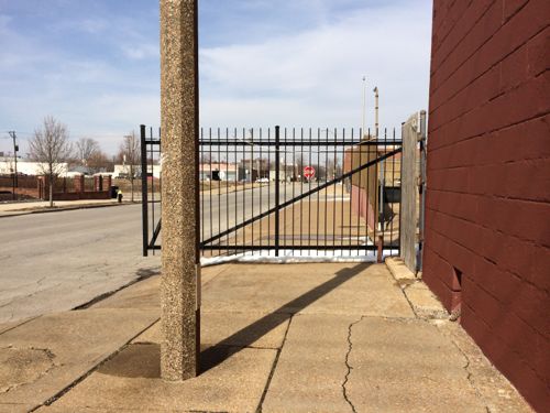 The property to the north had a gate that blocked the public sidewalk, it was later removed