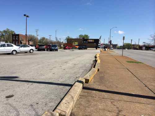 The separation between the Grand sidewalk and the parking lot is almost nonexistent 