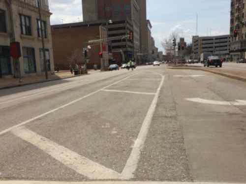 Looking south from the crosswalk crossing Tucker at Washington Ave we see space crossed out between the left turn land and two through lanes