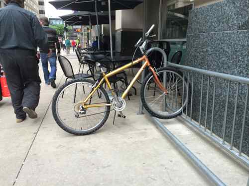 This May 2nd photo shows the tables & chairs still taking up as much space as a bike