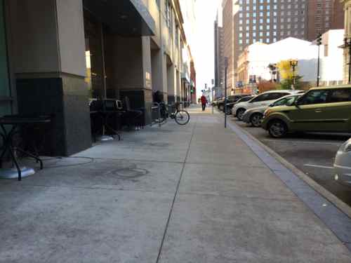 In November 2013 the tables & chairs were pushed aside for winter, not done in prior winters. The sidewalk was again clear. 
