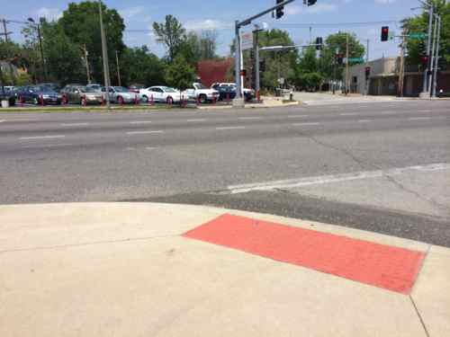 Looking back from across Gravois it isn't clear the ramp is to the left of the post. It's not clear to motorists this is a pedestrian crossing. 