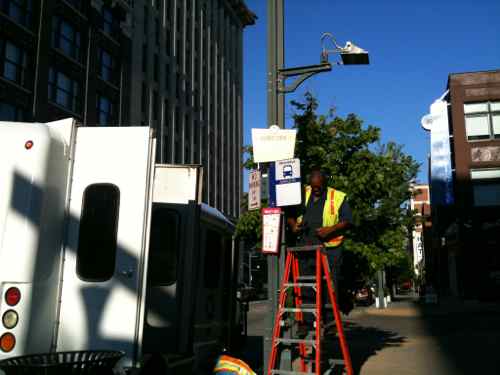 Worker installing the special trolley stop sign on Washington Ave, just west of 15th, on June 30, 2010 @ 6:30pm. 