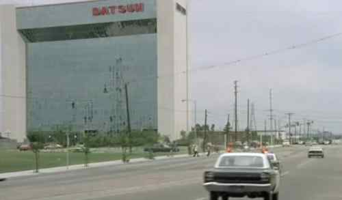 The chase scene passes by the USA headquarters of Datsun