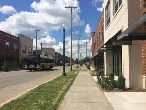 New construction on the west side of Sarah (right) gives an urban feel missing in the original only on the east side of Sarah.