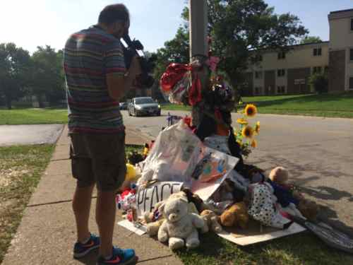 Next to the sidewalk there are more items as a tribute to Michael Brown