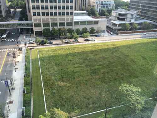 From the top of the adjacent parking garage you can see fenced-in prairie. 