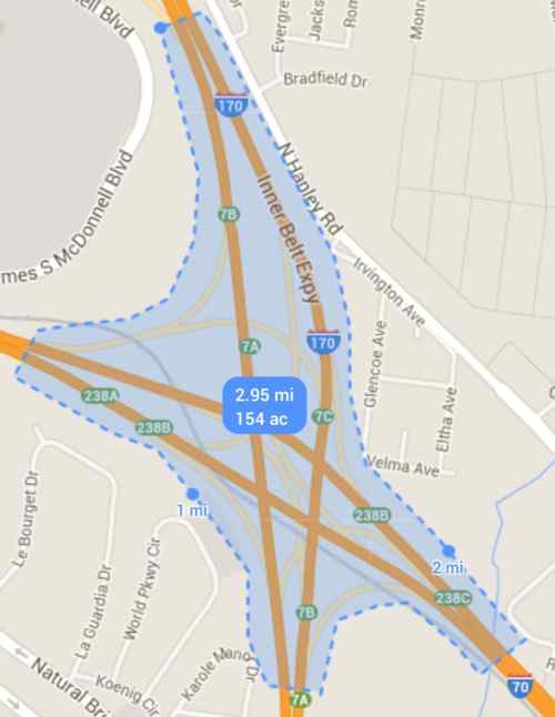 Using Google Maps I calculate this interchange consumes 154 acres, about 1/4 of a square mile