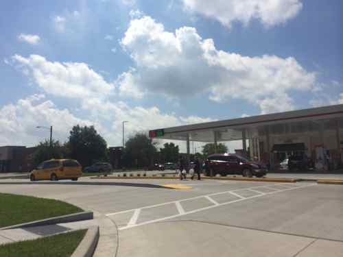 Two pedestrians ignore the circuitous route and walk directory to exit.