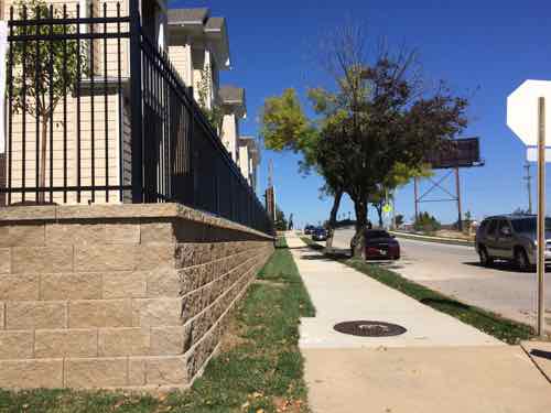 The east side faces Chouteau Park (right) but isn't oriented to it