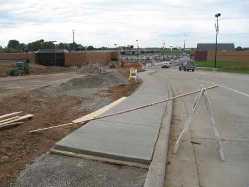 By the next month the developer was adding a sidewalk to the east side of the entrance drive.  Eventually the other side also received an access route. 