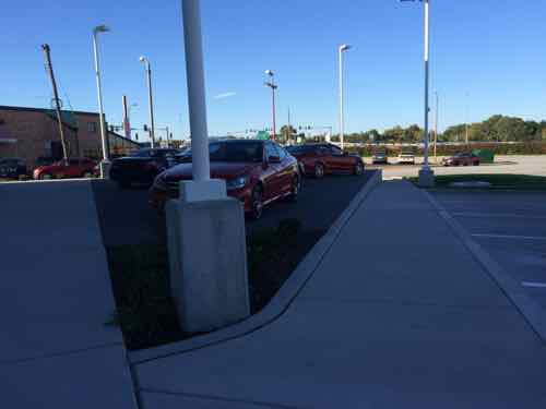 View from near the east-facing showroom entrance, looking down the accessible route to the Clayton Ave public sidewalk