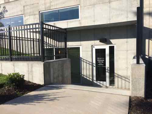 Customers dropping off or picking up their Mercedes-Benz do so up on the main level, but visiting the parts department requires a short flight of stairs that lack handrails. The grade change on Berthed Ave would've permitted an accessible entry.  