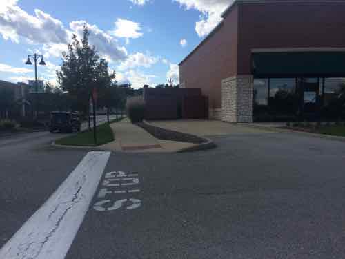 Looking back west you can see someone forgot to consider making sure wheelchairs/strollers could cross the driveway leading to dumpsters. Easy mistake  , easy fix. 