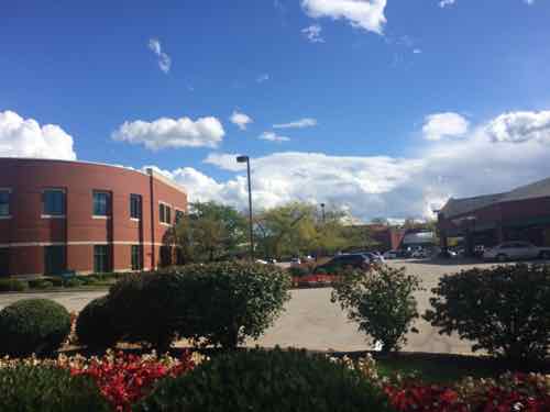 View of the various buildings from the public sidewalk. Maybe access is off of Woods Miill? 