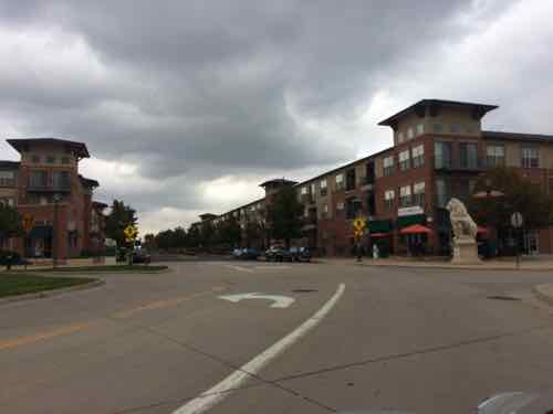 The light rail station is to the left, the Walmart down the road to the right. Yes, a Walmart is across the street from a large 3-story apartment building that has street-level retail.  