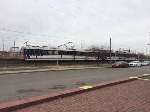 Looking toward the transit station from the market's door we see a WB train