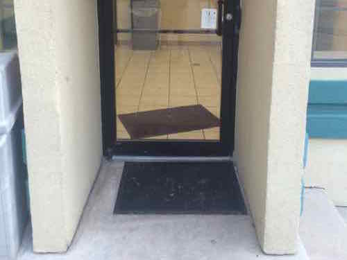 Both entrances to the newer building containing their rooms for the disabled had zero to the side of the pull side of the door.