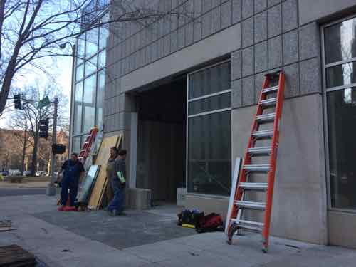 Workers building out the interior of the new Papa John's 2 blocks South in the Park Pacific garage. 