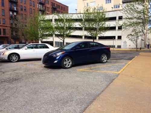 The blue Hyundai is parked in the one disabled spot -- without plates or hangtag