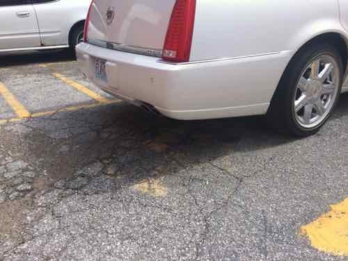 Now a Cadillac is parked in the disabled spot without disabled plates/placard