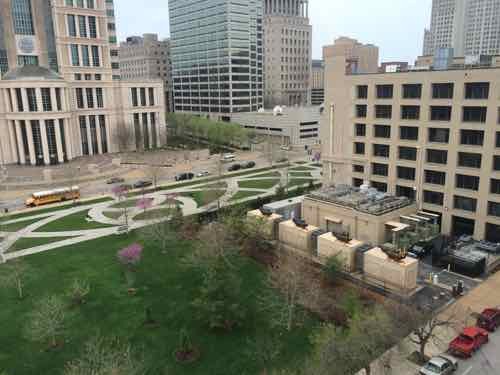 The NW corner of 9th &amp; Clark is owned by Digital Realty as part of their 900 Walnut data center (right) The background park with patterned walkways is owned by the federal government, related to the federal courthouse across the street.