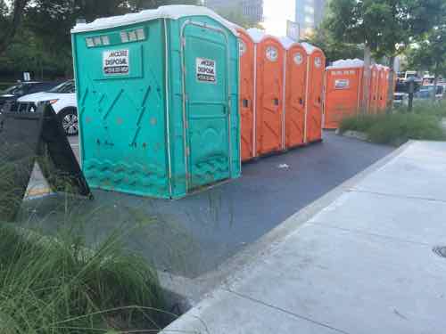 The restaurant building has restrooms accessed from the outside, but the capacity isn't enough &/or isn't visible enough. -- so porta-potties are added in a few parking spots. 