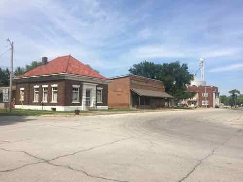 These buildings face the square 00 love the corner building with the peaked clay tile roof. 