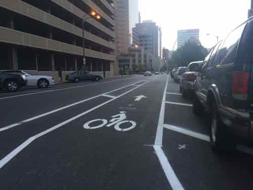 Looking East toward 11th, not sure why the bike lane isn't on the right side of these parked cars. I see two possibilities: 1) not enough width, and 2) would create an angle crossing 11th. 