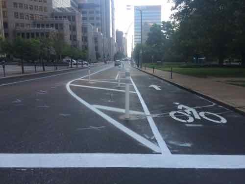 The lane resumes  being protected by parking East of 11th. Twain is on the right, 